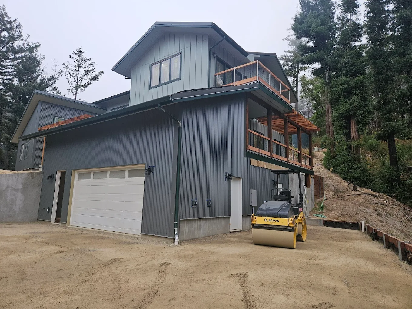A mountain home by SB Construction with fire-resistant metal roofing and siding and cleared defensible space around it.